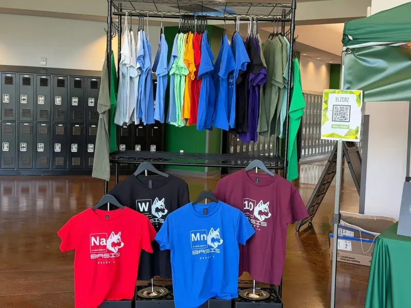 A rack of spirit shirts in every colour beside the lockers, four element shirts displayed on stands in front
