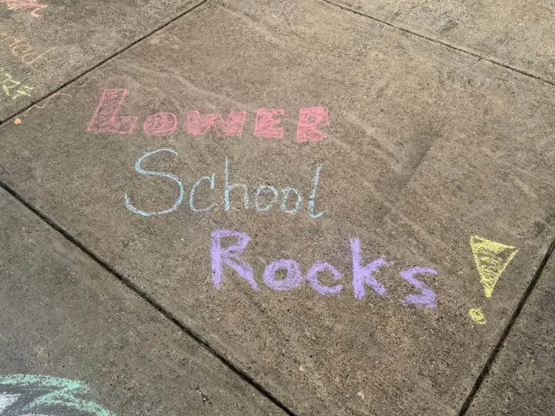 “Lower School Rocks!” chalked across a paving slab in pink, blue, purple and yellow