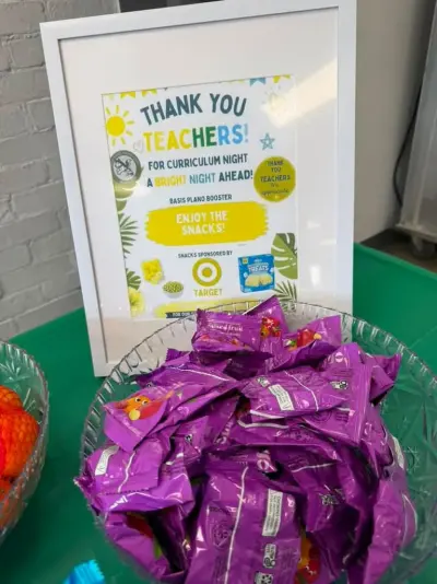 A framed ‘Thank you teachers — snacks sponsored by Target’ sign beside a bowl of fruit snack packets