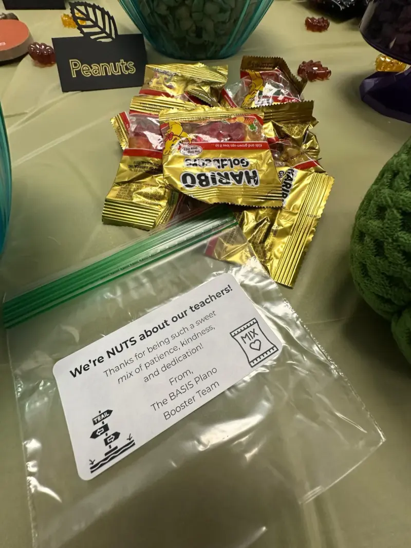 A zip bag of sweets with a printed tag reading “We’re NUTS about our teachers”, sat beside the peanuts bowl