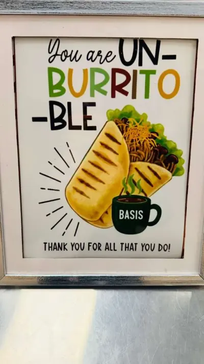 A framed sign reading “You are UN-BURRITO-BLE — thank you for all that you do”, illustrated with a burrito and a BASIS coffee mug